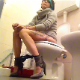 A short-haired brunette girl wearing heels and a dress sits down on a toilet and immediately farts and pisses. About a minute into the clip, some very subtle pooping sounds can be heard. She sits there for a while before wiping. Over 3.5 minutes.